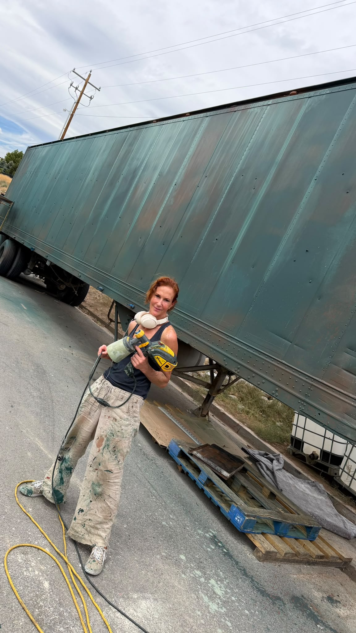Artst the process of painting a truck green and rust.